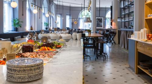 a buffet line with food in a restaurant at Clarion Collection Hotel Borgen in Örebro