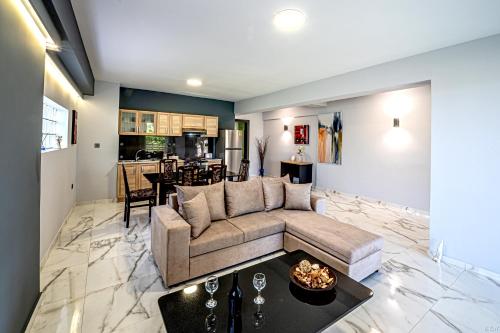 a living room with a couch and a table at “Villa Chrysa” luxury house in Flámbouras