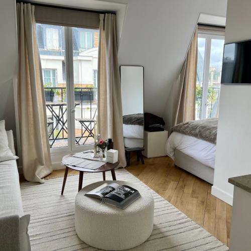 - une chambre avec un lit et une table basse dans l'établissement Michel Ange Casa in Paris, à Paris