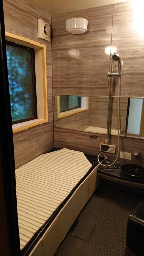 a small room with a bed and a window at Stage YOU in Tokyo