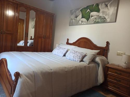 a bedroom with a large bed with two pillows at A casa do campo in Zas
