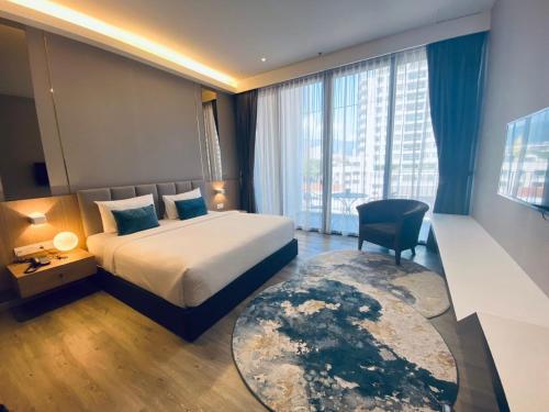 a hotel room with a bed and a large window at Corner Club Penang in George Town