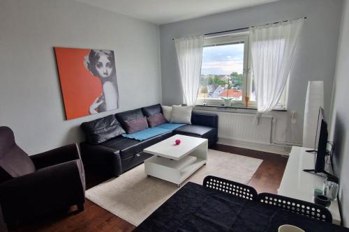 a living room with a couch and a table at Central boende med gång avstånd till centrum och lasarettet in Motala
