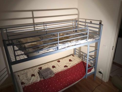 a bunk bed with a red mattress in a room at Chill and stay in Ösmo