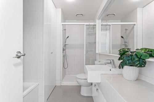 a bathroom with a toilet and a sink and a shower at Skyline City Zen in Melbourne