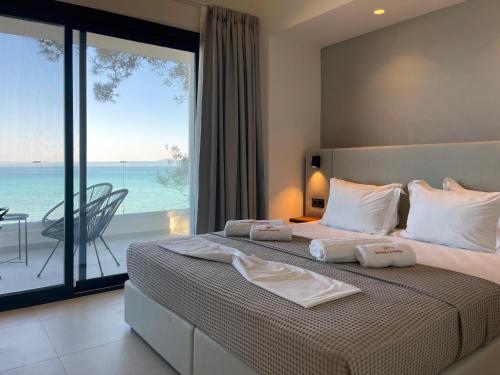 a bedroom with a bed with a view of the ocean at Villa Adele in Polychrono