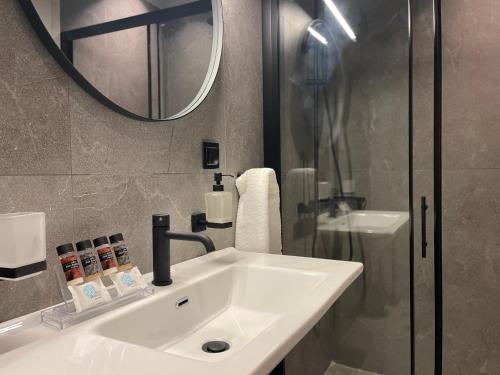 a bathroom with a white sink and a mirror at Villa Adele in Polychrono