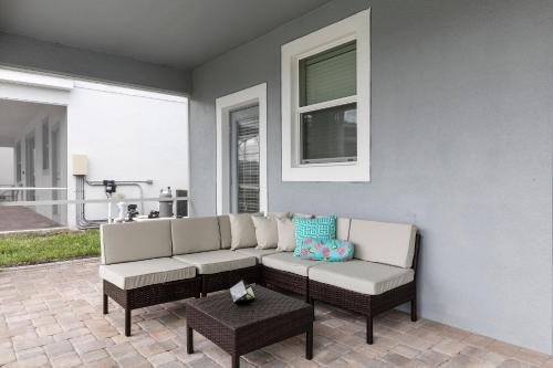 a living room with a couch and a table at 1509 MC - Exquisite 8BR Villa with Pool Games in Davenport