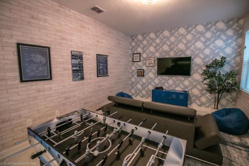 a room with a ping pong table and a tv at 1581 PD - Exquisite 6BR Haven: Private Pool in Davenport