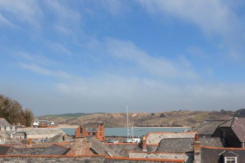 a group of roofs of buildings and a body of water at 10 Mill Road in Padstow
