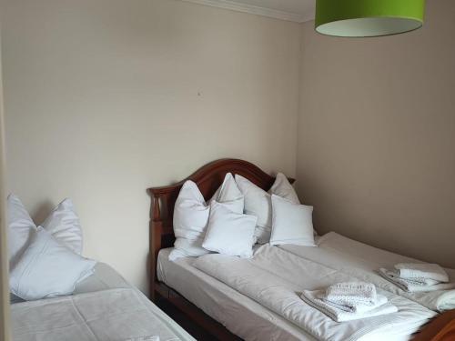 a bed with white pillows in a room at 0338 Apartment in Sanxenxo in Granxa