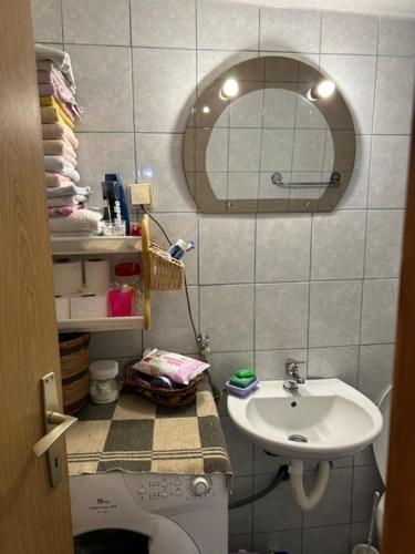 a bathroom with a sink and a toilet and a mirror at Nina's house in Rijeka Crnojevića