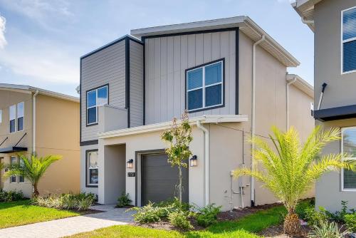 a house with a garage and palm trees at 2751 BD -Luxury 5BR Single Family - Private Pool in Kissimmee