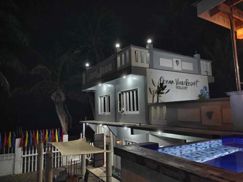 a building with a swimming pool at night at Private Home Ocean View Resort Talaonga in Sorsogon