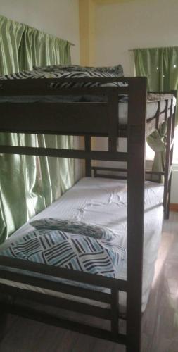 a group of three bunk beds in a room at Casa Vacanza Talaonga Ocean View Resort -Viajeros Booking Services in Sorsogon