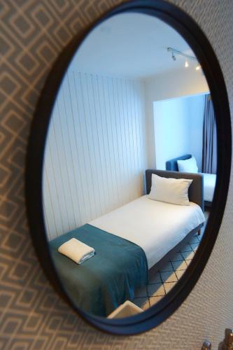 a mirror reflection of a bed in a room at PRIMA APARTMENTS in Satu Mare