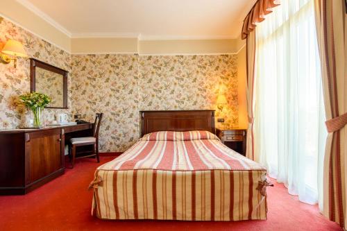 Postel nebo postele na pokoji v ubytování Boutique Splendid Hotel