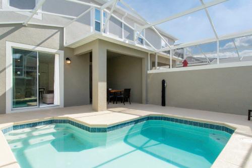 a large swimming pool in a house with a roof at 1056 LS - Luxury 4BR3BA - Champions Gate Bliss in Kissimmee