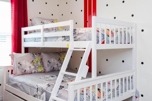 a childs bedroom with white bunk beds at 1798 TP - 4BR Luxury Solara Retreat Pool Disney in Orlando