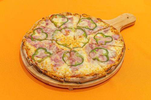 a pizza sitting on top of a wooden board at Faros I in Piraeus