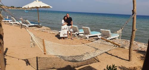 a man and a woman standing on the beach at Panorama Lodge Nuweiba in Nuweiba