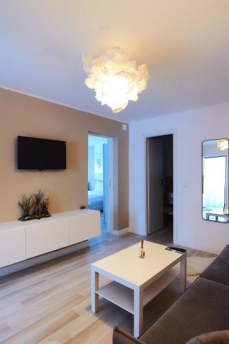 a living room with a couch and a table at PRIMA APARTMENTS in Satu Mare
