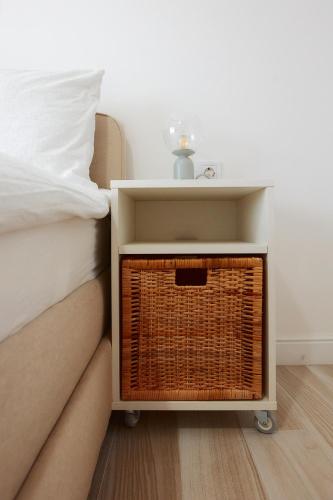 a bed with a night stand next to a bed at PRIMA APARTMENTS in Satu Mare