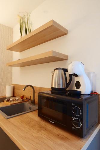 a microwave sitting on top of a kitchen counter at PRIMA APARTMENTS in Satu Mare