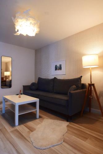 a living room with a couch and a table at PRIMA APARTMENTS in Satu Mare