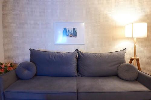 a couch with large pillows in a living room at PRIMA APARTMENTS in Satu Mare