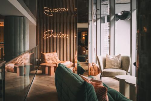 a store with couches and chairs in a room at Hotel Enzian - Adults Only in Obertauern