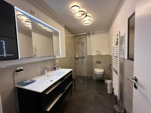 a bathroom with a sink and a toilet at Apartment Hideaway in Bad Oeynhausen