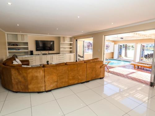 a large living room with a large brown couch at Villa on Maxi in Velddrif