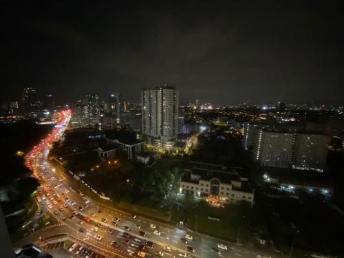 uma cidade iluminada à noite com edifícios e tráfego em Affordable Residence Plaza @ KJ em Petaling Jaya