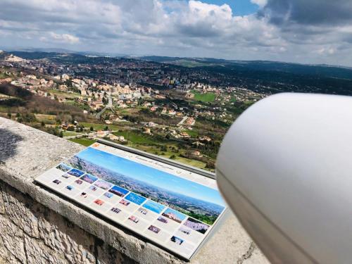 a tablet on a ledge with a view of a city at BB Diesis in Ferrazzano