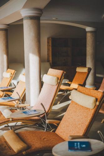 a row of chairs in a room with columns at Hotel Enzian - Adults Only in Obertauern