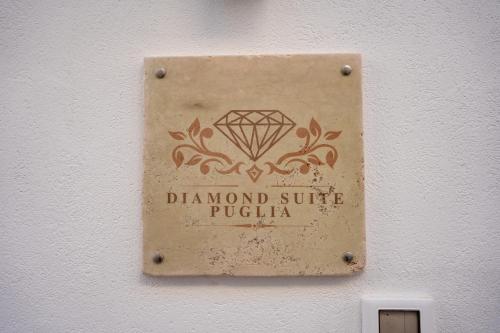 a sign on a wall with a diamond sign on it at Diamond Suite Puglia in Ceglie Messapica