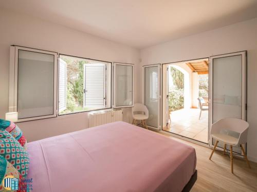 a bedroom with a large bed and a balcony at Villa colette in Sant Antoni de Calonge