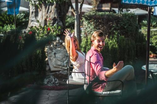 a man and a woman sitting in a chair at Magic Robin Hood in Albir