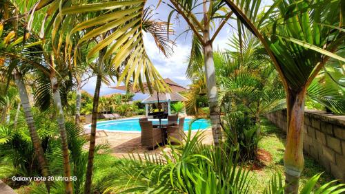 a resort with a swimming pool and palm trees at Mahafaly Hotel & Resort in Antsirabe