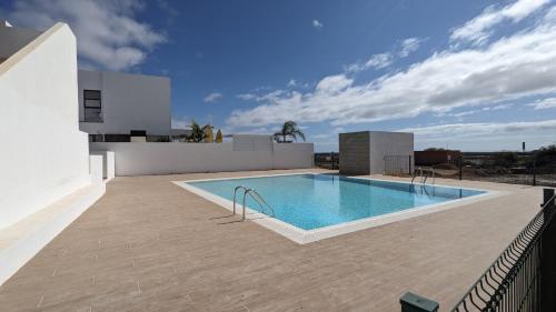 a swimming pool on the roof of a house at Casa Fuerteremote - new and modern house with office in Corralejo in La Oliva