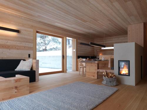 a living room with a couch and a fireplace at Mountain Lodge Tamersc in San Vigilio Di Marebbe