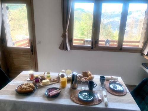 a table with plates of food on top of it at Chalet Le Tilleul in Valdeblore