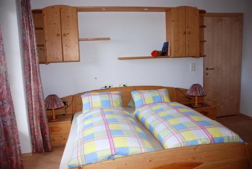 a bed with two pillows on it in a room at Blaserhof in Hainzenberg