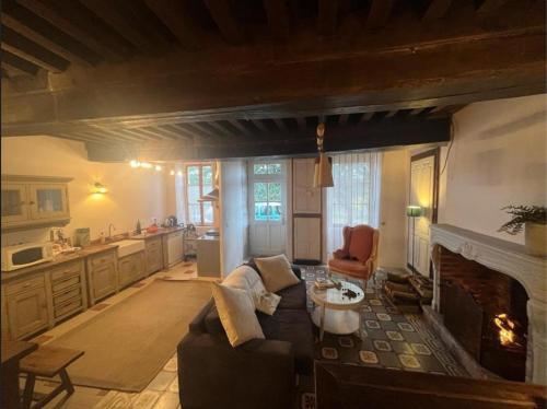 a living room with a couch and a fireplace at Gîte La Bancale in Lormes