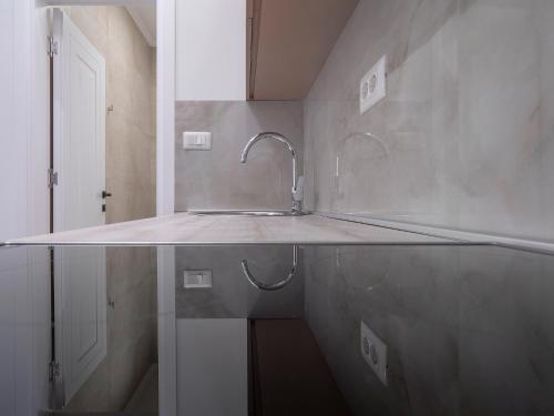 a kitchen counter with a sink in a room at Apartments Mary in Budva