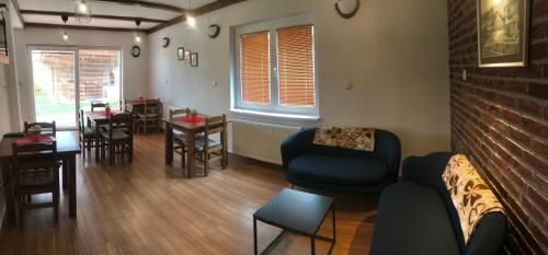 a living room with a couch and chairs and a table at Hestia Apartments in Berovo