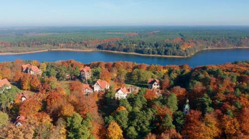 an aerial view of a house on a hill next to a lake at Parkresidenz Lychen, Ferienwohnung 5 in Lychen