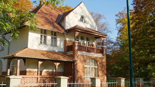 an old house with a porch on the side of it at Parkresidenz Lychen, Ferienwohnung 4 in Lychen