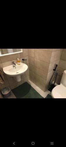 a bathroom with a sink and a toilet at Appartement costa mar Martil in Martil